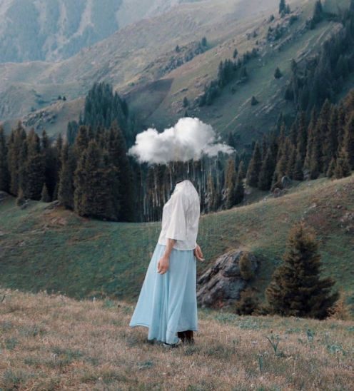 A person standing in a field with a cloud as their head, symbolizing imagination and escapism.